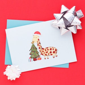 Girafe décorant le sapin de Noël | Carte de vœux des Fêtes