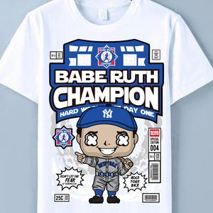 May include: White t-shirt featuring a cartoon illustration of Babe Ruth in a baseball uniform. The design includes the text "Babe Ruth Champion" and "Hard Work Day One". The shirt also has the text "Don't let the fear of striking out" and "Hold your back".