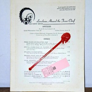 May include: A vintage menu titled "Luncheon Aboard the Texas Chief" with the Santa Fe logo. The menu features appetizers and entrees. A red ice cream spoon and a pink ticket are on the menu.