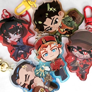 May include: A collection of five acrylic keychains featuring stylized chibi-style character illustrations. Each keychain includes a colorful metal lobster clasp and depicts a unique character with distinct hair colors, outfits, and accessories.