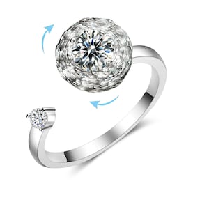 May include: A silver ring with a spinning, clear crystal ball set in the center. The ball is surrounded by smaller crystals.