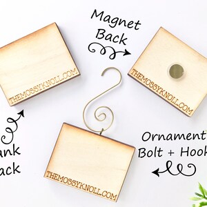 May include: Wooden square ornaments with a blank back, magnet back, and ornament bolt and hook. The text "THEMOSSYKNOLL.COM" is printed on the bottom of each ornament. The ornaments are light brown and have a natural wood grain.