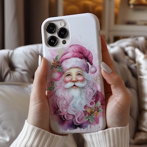 May include: White phone case featuring a watercolor illustration of Santa Claus. The design includes a pink Santa hat, a long white beard, and a rosy-cheeked face. The case has a glossy finish and a camera cutout.