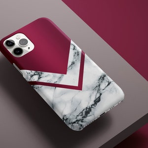 May include: A white and burgundy phone case with a marble pattern and geometric design.