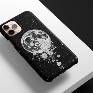 May include: Black phone case with a white moon and floral design on a black glitter background.