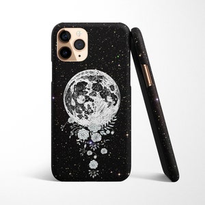 May include: Black phone case with a white moon and floral design on a black glitter background.