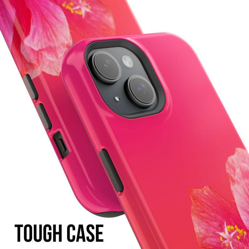 May include: A pink phone case with a floral design. The case has a raised camera bump and a cutout for the phone's buttons. The case is made of a durable material and is designed to protect your phone from scratches and drops.  TOUGH CASE