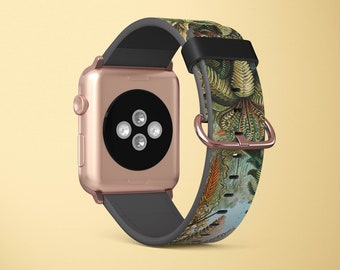 May include: A rose gold Apple Watch with a black and grey band. The band has a colourful, floral print with a detailed design.