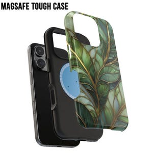 May include: A black phone with a MagSafe Tough Case. The case features a green and gold leaf design. The text "MAGSAFE TOUGH CASE" is at the top. The phone is partially disassembled, showing the phone, the case, and the MagSafe component.