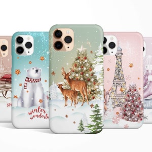 May include: Five different phone cases with winter holiday themes. The cases feature a polar bear, reindeer, Eiffel Tower, ice skates, and a Christmas tree. Each case has a white background with a glittery effect.