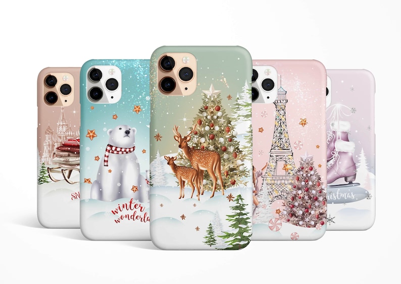May include: Five different phone cases with winter holiday themes. The cases feature a polar bear, reindeer, Eiffel Tower, ice skates, and a Christmas tree. Each case has a white background with a glittery effect.