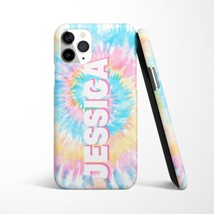 May include: A phone case with a tie-dye pattern in shades of blue, pink, and yellow. The name "JESSICA" is printed in white with a pink outline on the case.