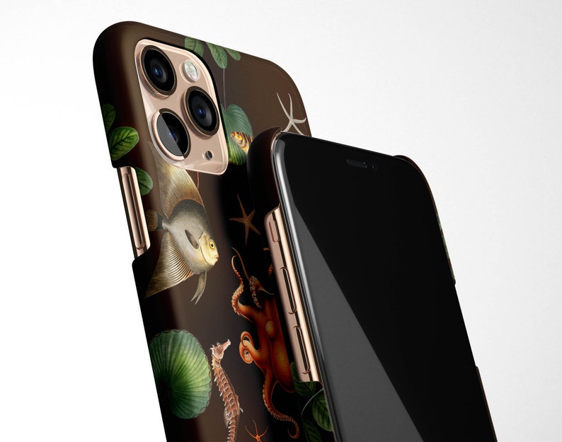 May include: A black phone case with a gold trim and a colorful illustration of sea life, including an octopus, a seahorse, and a fish. The case is designed for an iPhone.