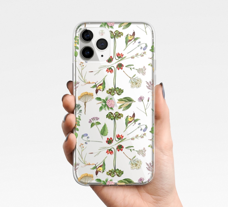 May include: Clear phone case with a floral pattern featuring various flowers and plants in shades of green, yellow, pink, and red.