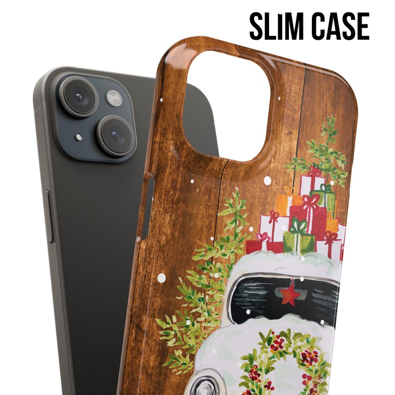 May include: A phone case with a woodgrain background and a white vintage car with a pile of wrapped presents on top. The car has a red star on the front and a wreath of holly on the front bumper.