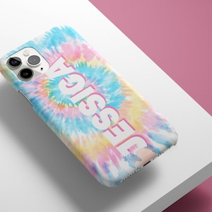 May include: A white iPhone case with a tie-dye pattern in shades of blue, pink, and yellow. The name "Jessie" is printed in white on the case.