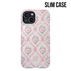 May include: A clear phone case with a pink and white floral pattern and a pink ribbon design. The case has a letter "B" in the center.