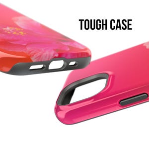 May include: Two phone cases, one with a pink floral design and the other a solid pink. Both cases have a black rubber bumper and a raised camera lens protector. The text "TOUGH CASE" is printed in black on a white background.