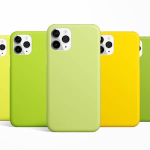 May include: Five phone cases in different colors: yellow, green, light green, and a darker green. The cases are all made of silicone and have a smooth finish.