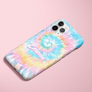 May include: A colorful phone case with a tie-dye design in shades of blue, pink, yellow, and white. The name "Emma" is printed in a cursive font across the case. The phone case has a camera and flash.