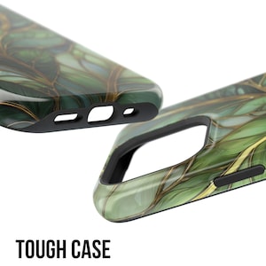 May include: Two phone cases with a green and gold leaf design. The cases are black around the edges and have cutouts for the phone's features. The text "TOUGH CASE" is printed in bold, white letters at the bottom.