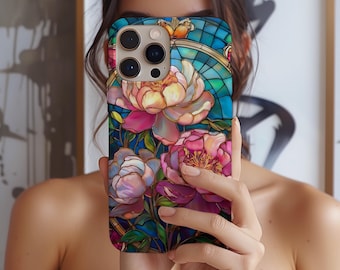 May include: A phone case with a stained glass design featuring pink, white, and blue flowers on a blue background.