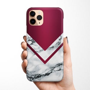 May include: A white marble phone case with a burgundy chevron design. The case has a camera cutout and a sleek, modern look.