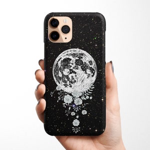 May include: Black phone case with a white moon and floral design on a black starry background.
