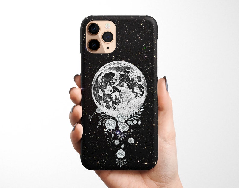 May include: Black phone case with a white moon and floral design on a black starry background.