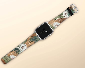 May include: A silver Apple Watch with a floral patterned band. The band features white flowers, green leaves, and a brown wood-like pattern.