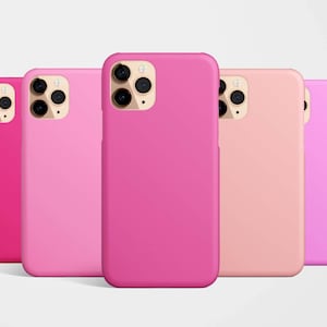 May include: Five phone cases in a range of pink hues, including pink, light pink, peach, and lavender. All cases feature the same design with a raised camera bump.
