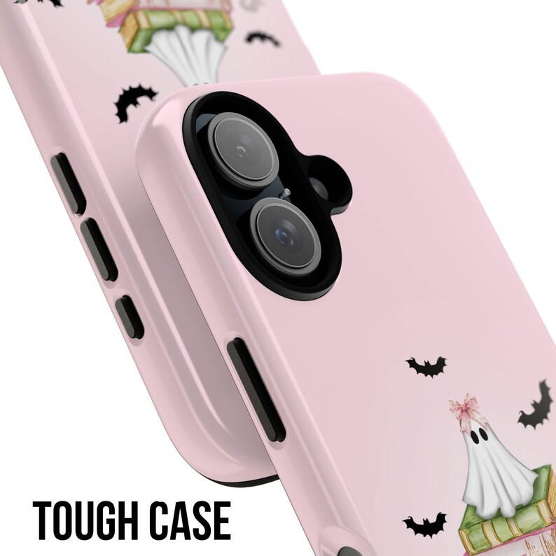 May include: A pink phone case with a ghost and bats design. The case has a "TOUGH CASE" label.