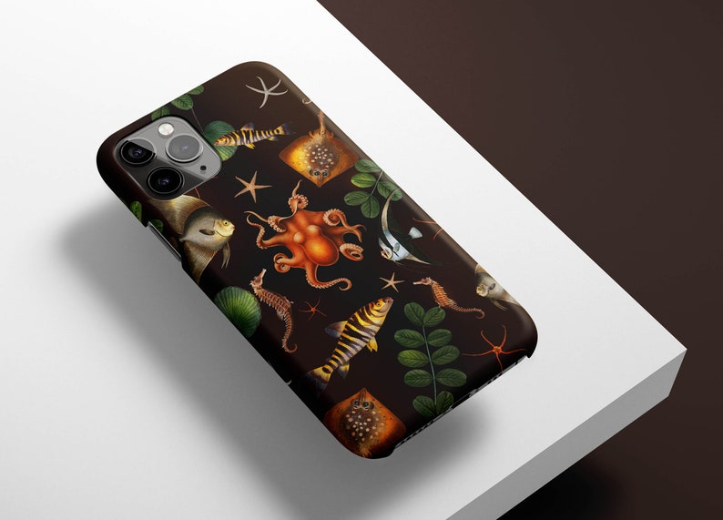 May include: A black phone case with a colorful underwater design featuring an octopus, fish, seahorses, and starfish. The case has a dark background and a variety of colors, including orange, yellow, and blue.