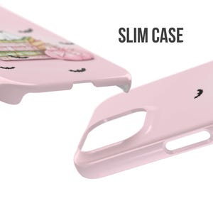 May include: A pink phone case with a cute cartoon design featuring bats and a spooky character. The case is labeled "SLIM CASE".