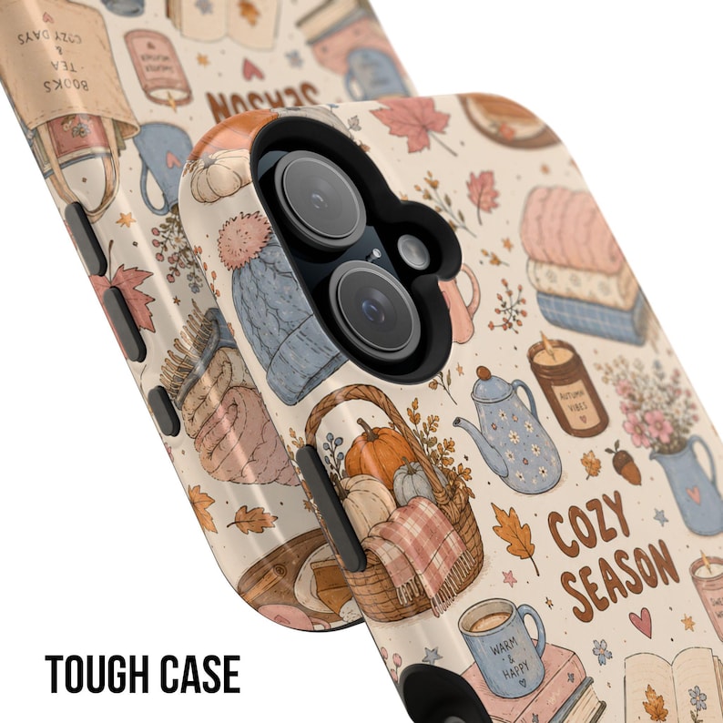 May include: A phone case with a cream background featuring a repeating pattern of autumn-themed illustrations including pumpkins in a basket, knit hats, tea kettles, candles, books, and mugs. The text COZY SEASON is printed in brown letters.