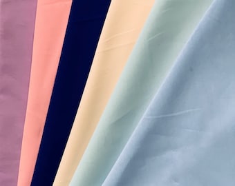 May include: Five fabric swatches in different colors: lavender, pink, navy blue, beige, and light blue.