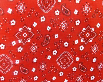 May include: Red bandana fabric with a white paisley pattern. The fabric has a repeating pattern of paisley shapes, diamonds, and stars.