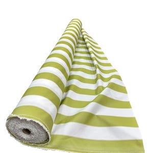 May include: A roll of green and white striped fabric. The fabric is unrolled, revealing the pattern. The stripes are wide and evenly spaced. The fabric is likely cotton or a similar material, suitable for upholstery or crafting.