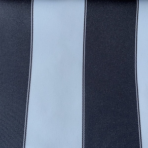 May include: Close-up of a fabric sample with a bold striped pattern. Alternating vertical stripes in navy blue and white create a classic design. The fabric has a textured appearance, and the edge is cut with a zig-zag pattern. Ideal for upholstery or outdoor use.
