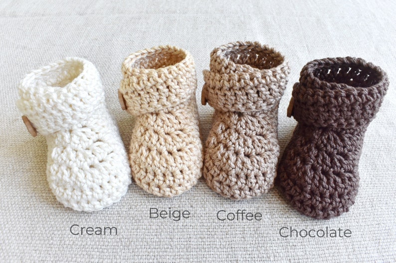 Pode incluir: Quatro pares de sapatinhos de beb&eacute; de croch&ecirc; nas cores creme, bege, caf&eacute; e chocolate. Cada sapatinho tem um detalhe de bot&atilde;o.
