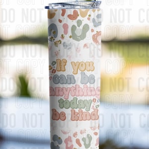 May include: A stainless steel tumbler with a white background and a colourful abstract pattern. The tumbler has a straw and the text "If you can be anything today be kind" in a retro font.
