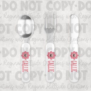 May include: A three-piece silverware set for a child. The set includes a spoon, fork, and knife. Each piece has a white handle with a pink flower design and the name "CALLIE" in pink. The spoon and fork are silver.