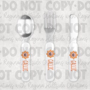 May include: A set of children's silverware, including a spoon, fork, and knife. Each piece has a white handle with an orange flower design and the name "CALLIE" in orange. The spoon and fork are silver.