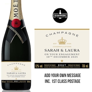 May include: A bottle of Moët champagne with a gold foil neck and a red seal. The label reads "Champagne" and features custom text for an engagement. The bottle is 750 ml.