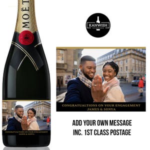 May include: A black Moët champagne bottle with a gold foil neck and a red seal. The bottle features a custom label with a photo of a couple and the text "CONGRATUALTIONS ON YOUR ENGAGEMENT JAMES & SONYA".