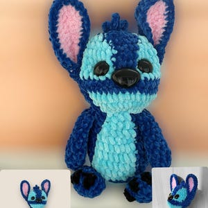 May include: A handmade blue and turquoise plush toy with large ears and black eyes. The plushie has a textured, fuzzy appearance and is a character from a popular animated film. The toy is displayed with two smaller images of the same character.