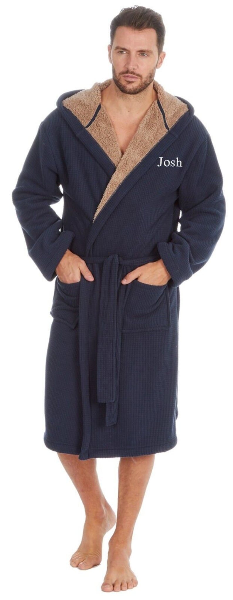 May include: A navy blue hooded robe with a brown sherpa lining. The robe has a belt and two pockets. The name "Josh" is embroidered on the robe.