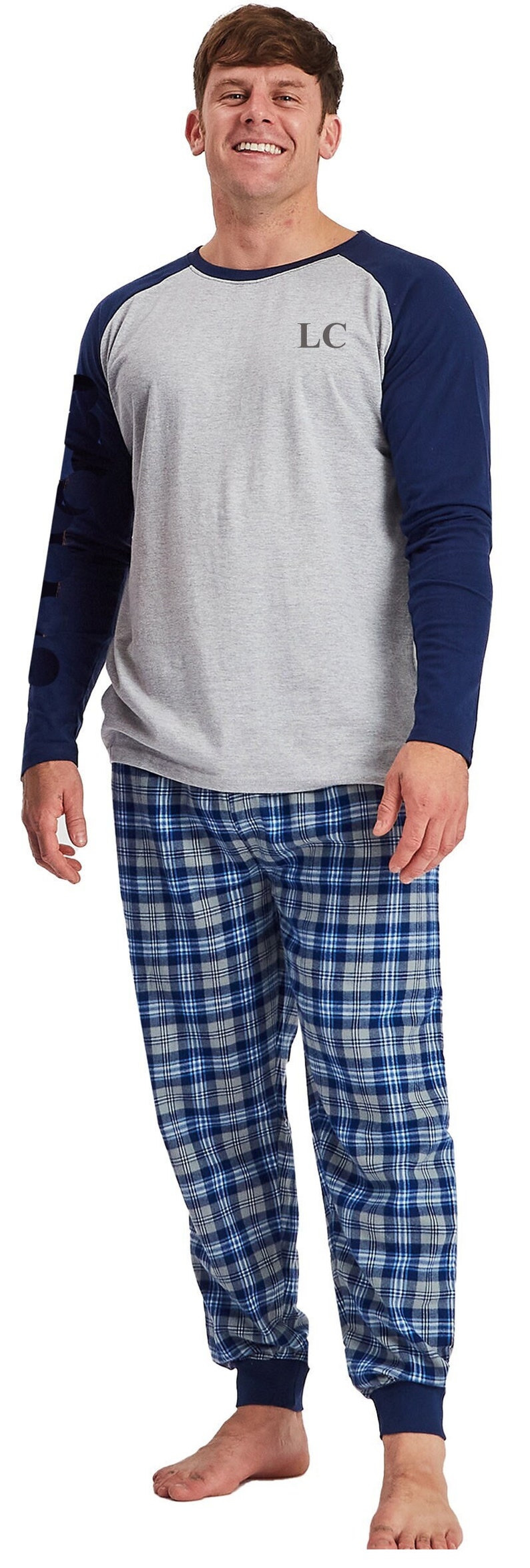 May include: A gray and navy blue long-sleeved pajama top with a blue and gray plaid pajama bottom. The top has a baseball style design with navy blue sleeves and a gray body. The top has the letters "LC" embroidered on the chest.
