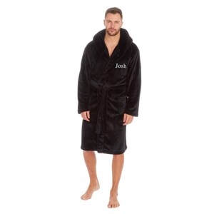 May include: Black hooded robe with a white embroidered name "Josh" on the front.