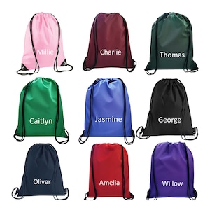 May include: Nine drawstring bags in various colours with names printed on them. The bags are: Millie, Charlie, Thomas, Caitlyn, Jasmine, George, Oliver, Amelia, and Willow.